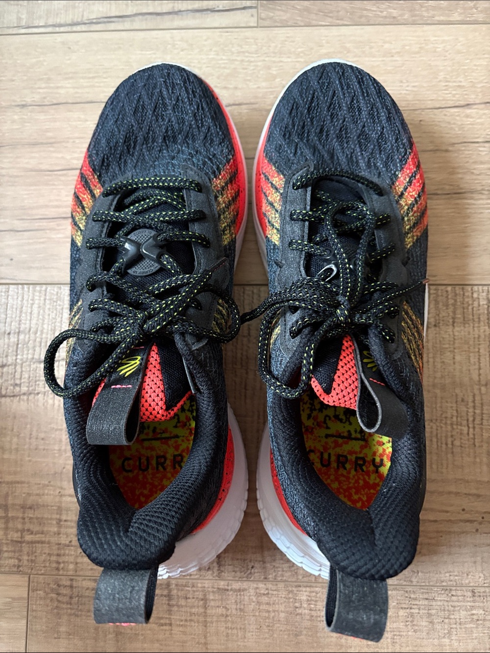 Curry Under Armour Men's Black Sneakers with Red and Yellow Accents